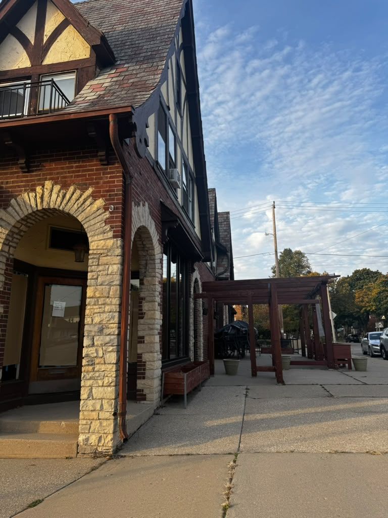 Arched brick entrances along the sidewalk