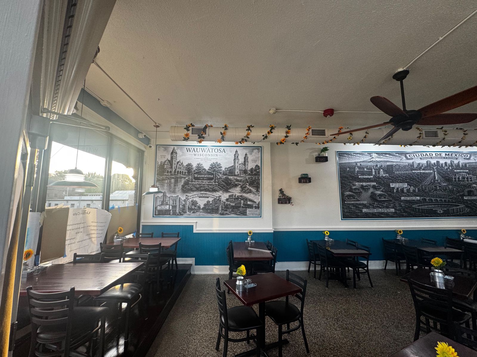 Dining room by the front windows with the Wauwatosa mural